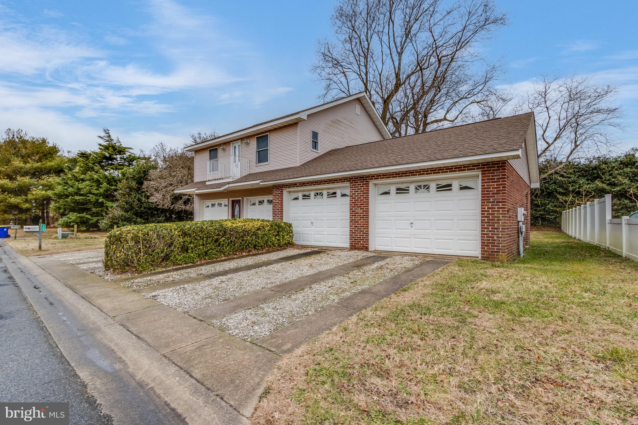 1-2 Harborview Road Lewes, DE 19958 - Photo 24 of 43 a front view of a house with a yard and garage