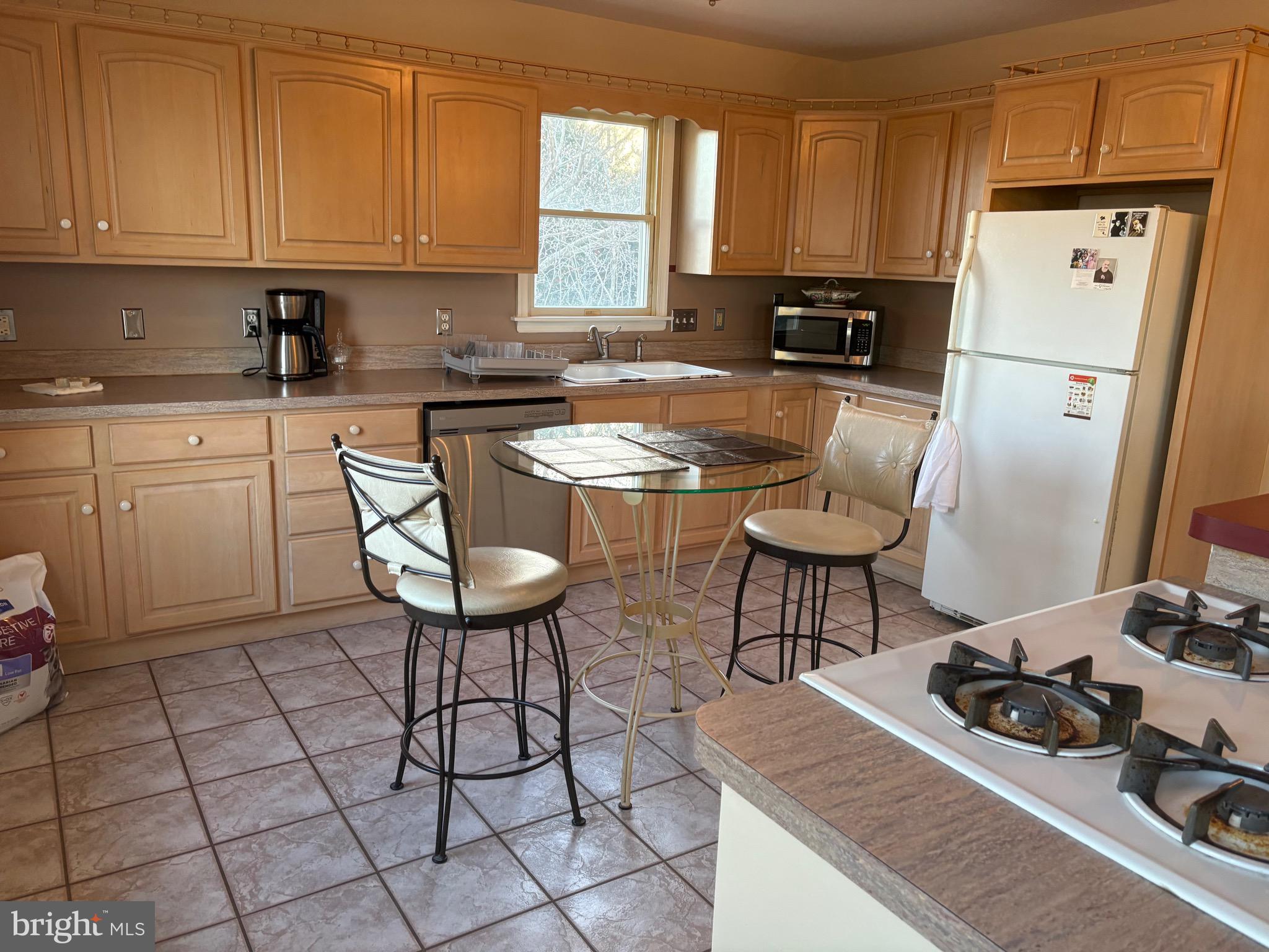 1-2 Harborview Road Lewes, DE 19958 - Photo 28 of 43 a kitchen with stainless steel appliances a stove a refrigerator sink and cabinets
