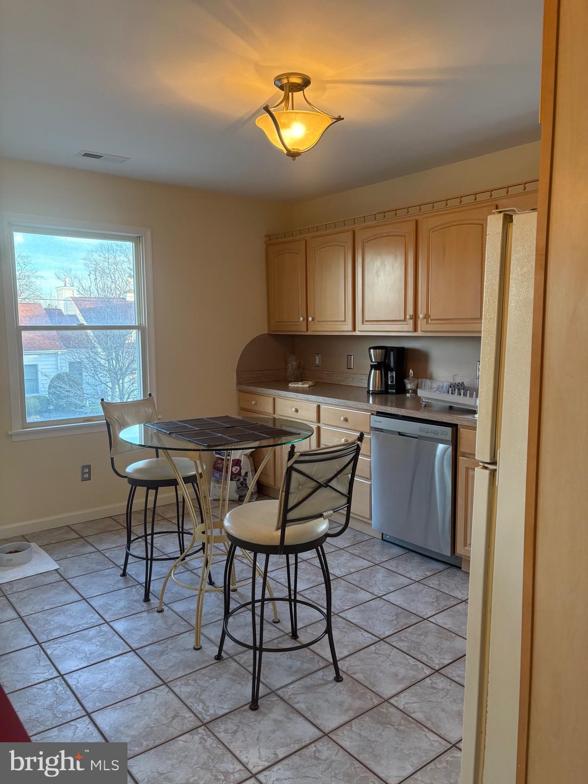 1-2 Harborview Road Lewes, DE 19958 - Photo 30 of 43 a kitchen with stainless steel appliances kitchen island granite countertop a sink a stove a table and chairs