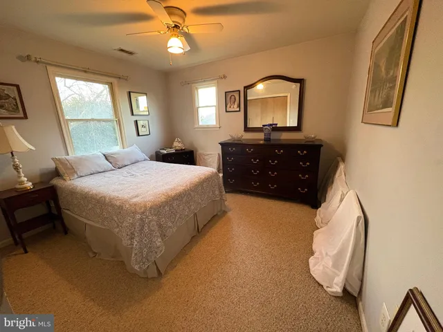 a spacious bedroom with a bed and furniture