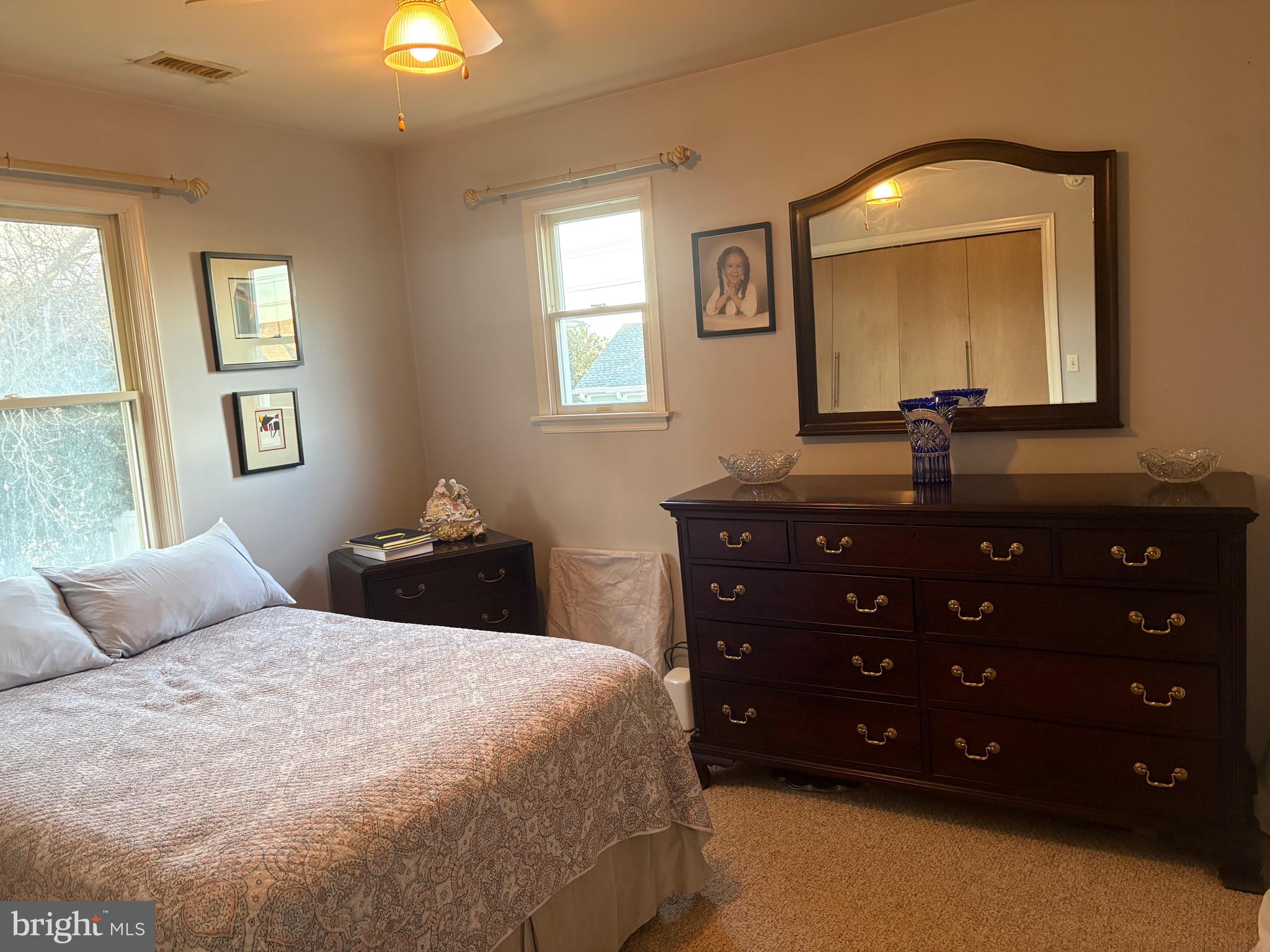 1-2 Harborview Road Lewes, DE 19958 - Photo 33 of 43 a bedroom with a bed and a mirror on dresser