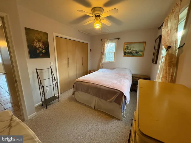 a bedroom with bed and window
