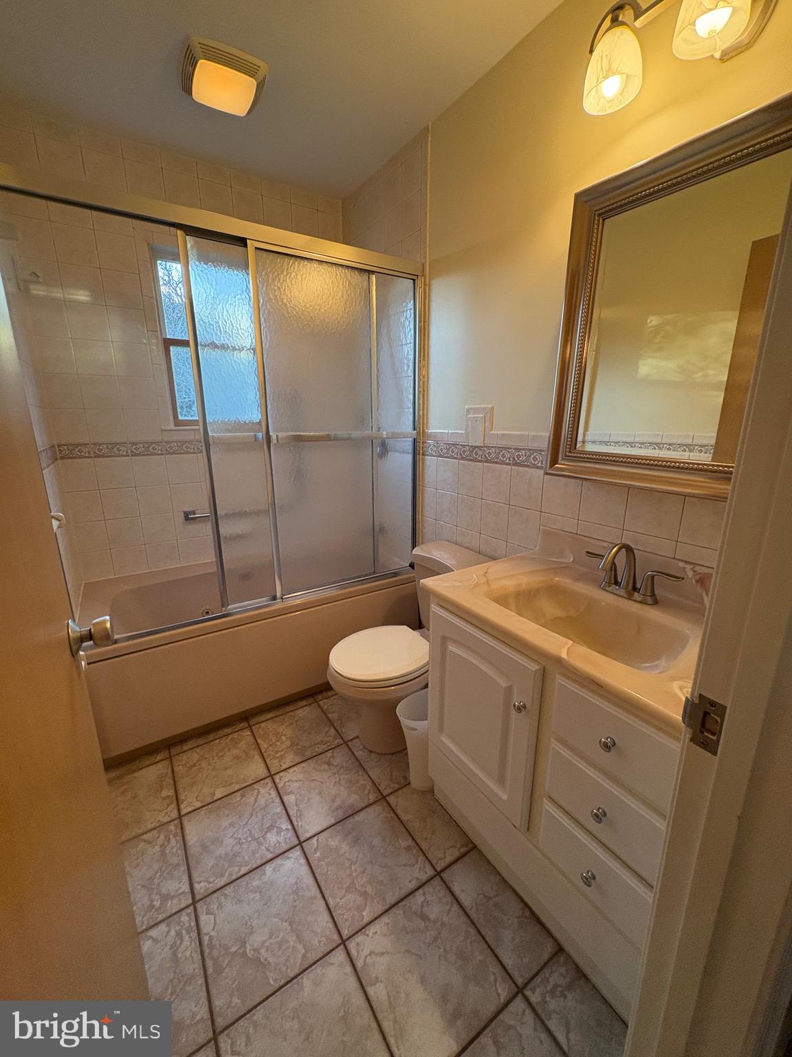 1-2 Harborview Road Lewes, DE 19958 - Photo 36 of 43 a bathroom with a granite countertop sink mirror vanity and toilet