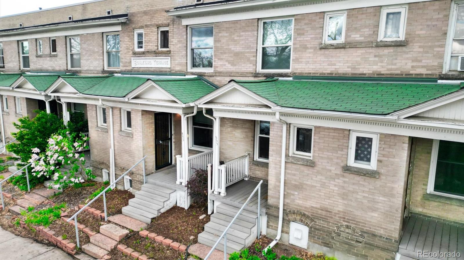 a front view of a house with a yard table and chairs