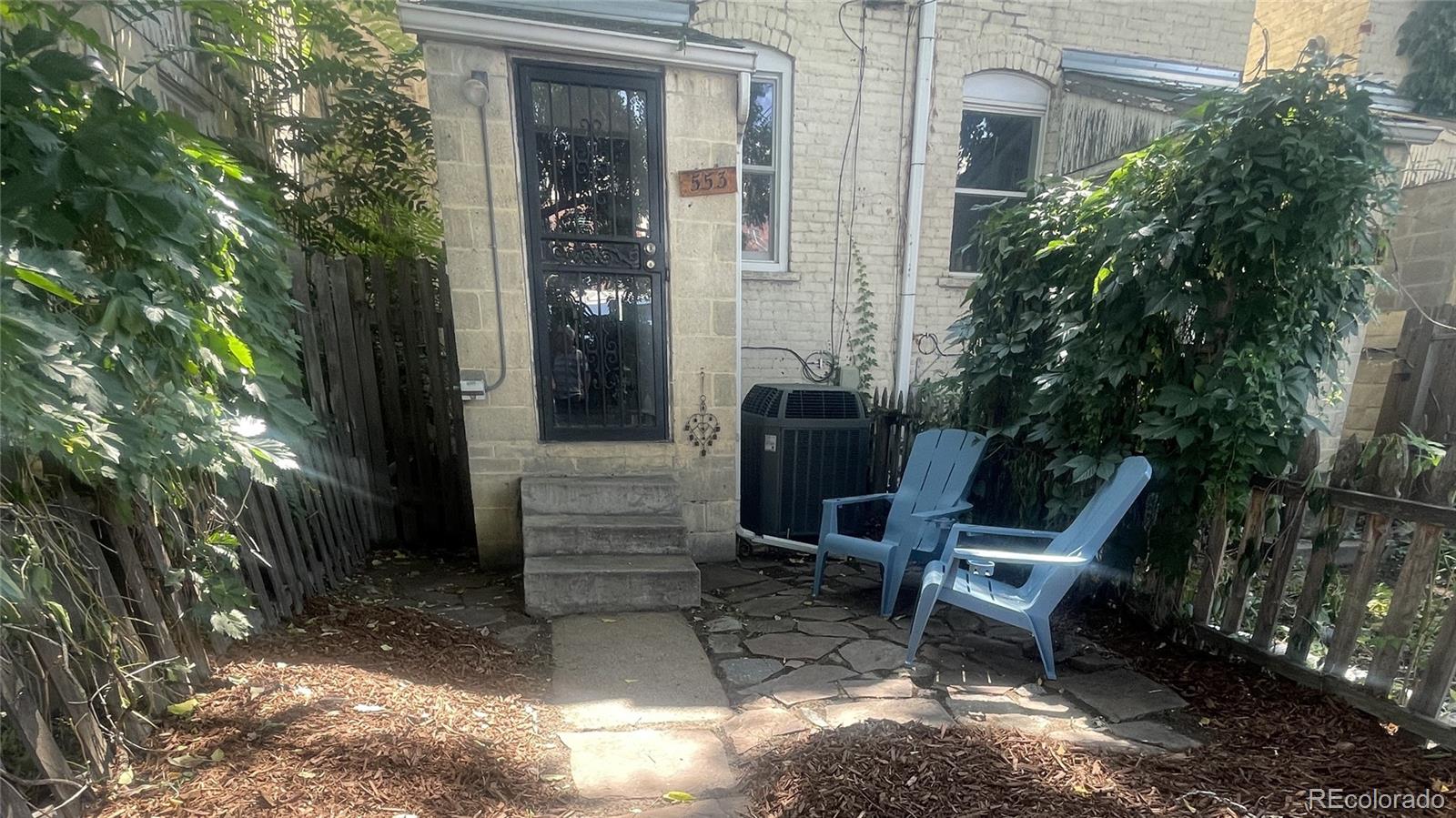 553 Logan Street Denver, CO 80203 - Photo 13 of 38 a view of a two chairs in back yard of the house