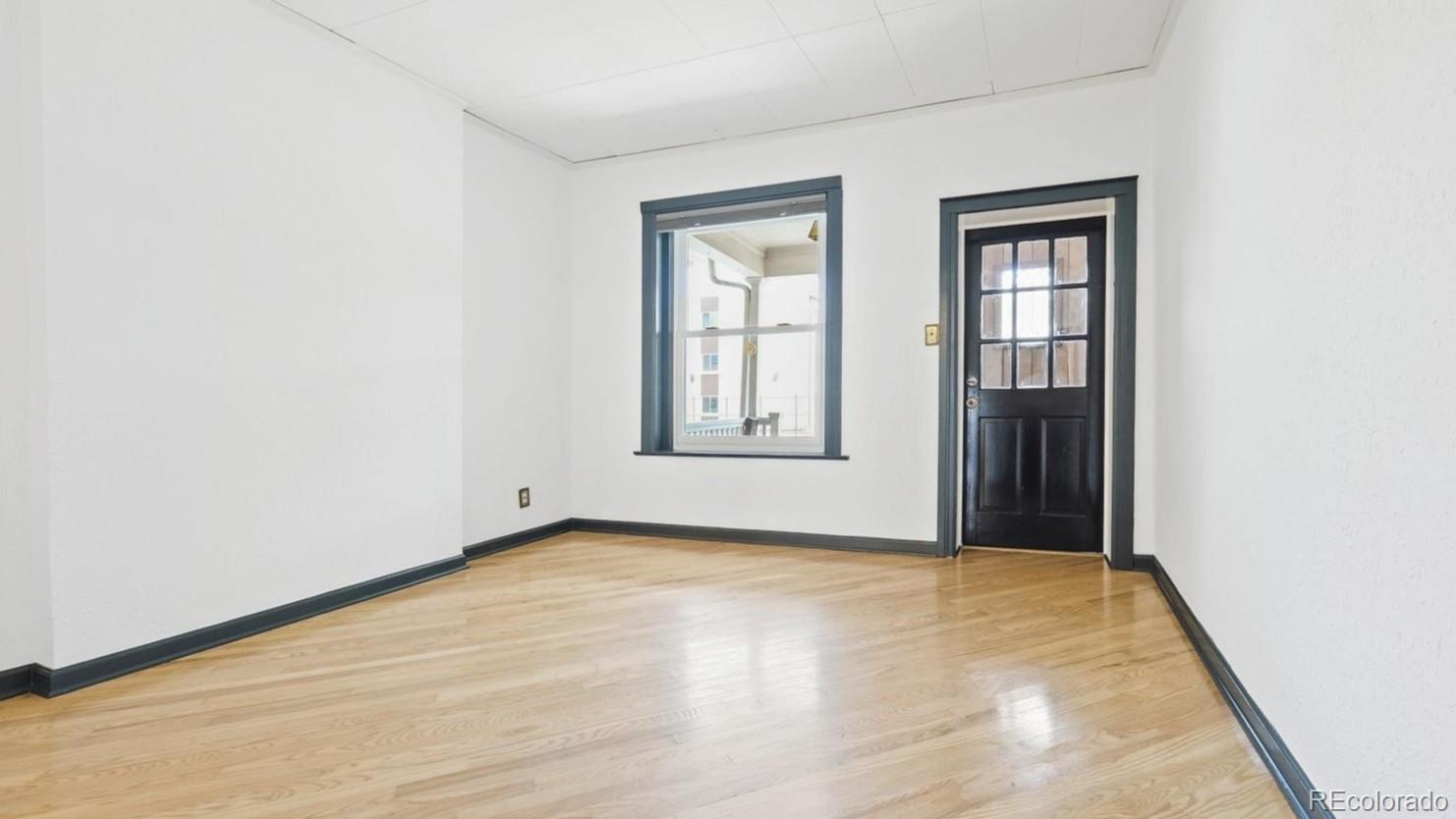 553 Logan Street Denver, CO 80203 - Photo 16 of 38 an empty room with windows and closet