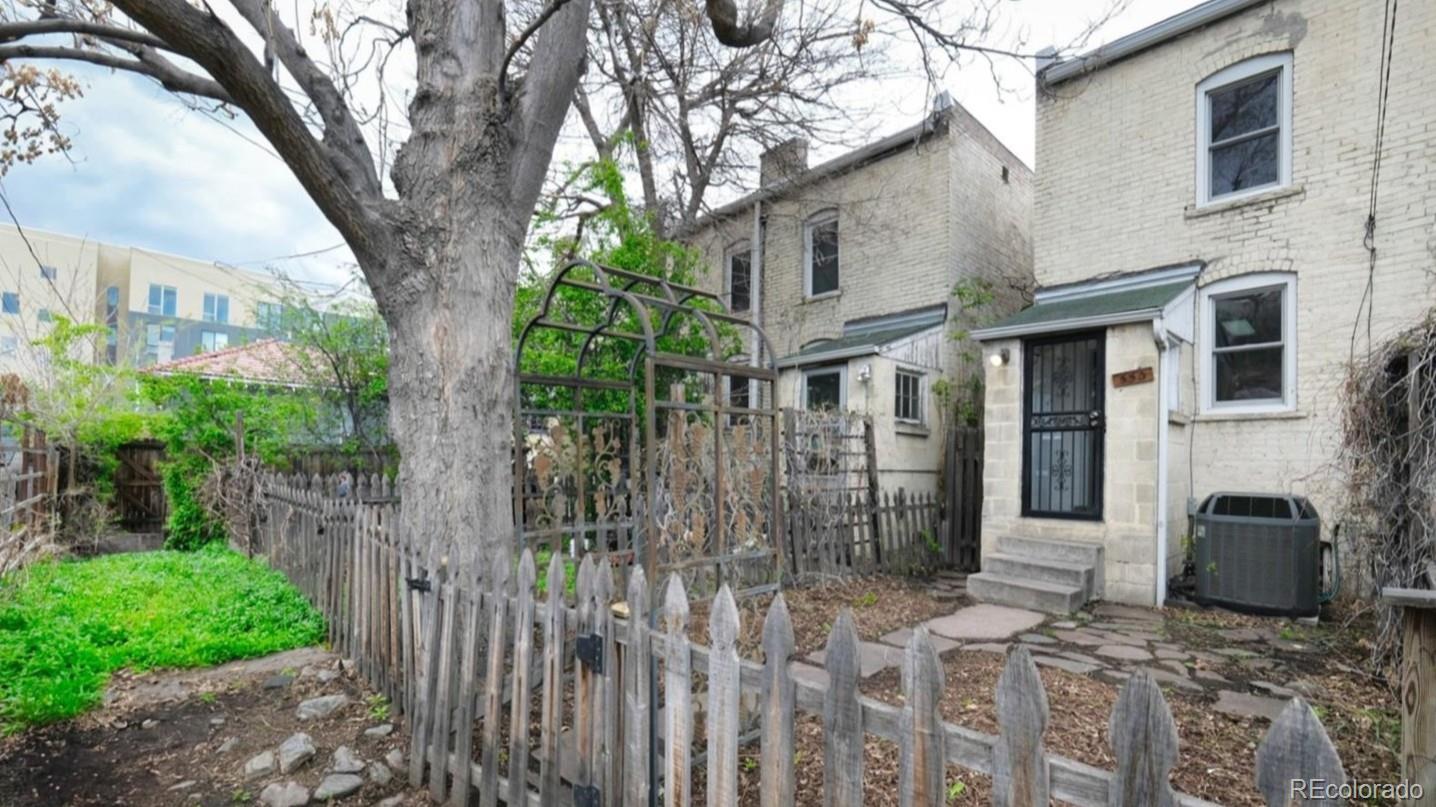 553 Logan Street Denver, CO 80203 - Photo 27 of 38 a front view of a house with a tree