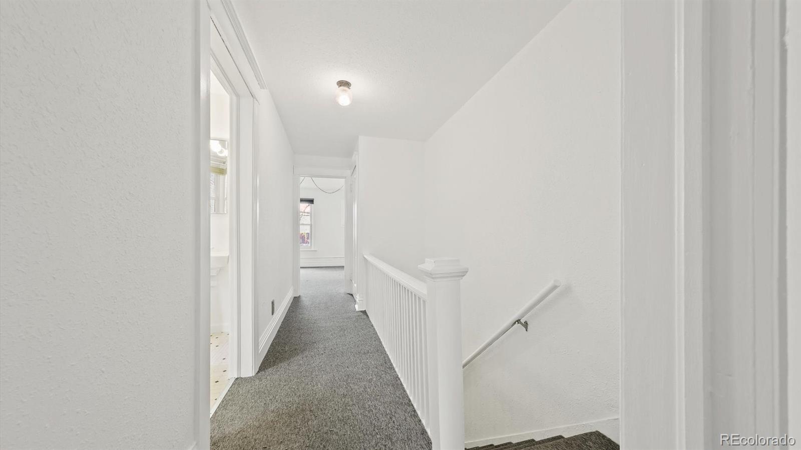 553 Logan Street Denver, CO 80203 - Photo 28 of 38 a view of a hallway with white walls