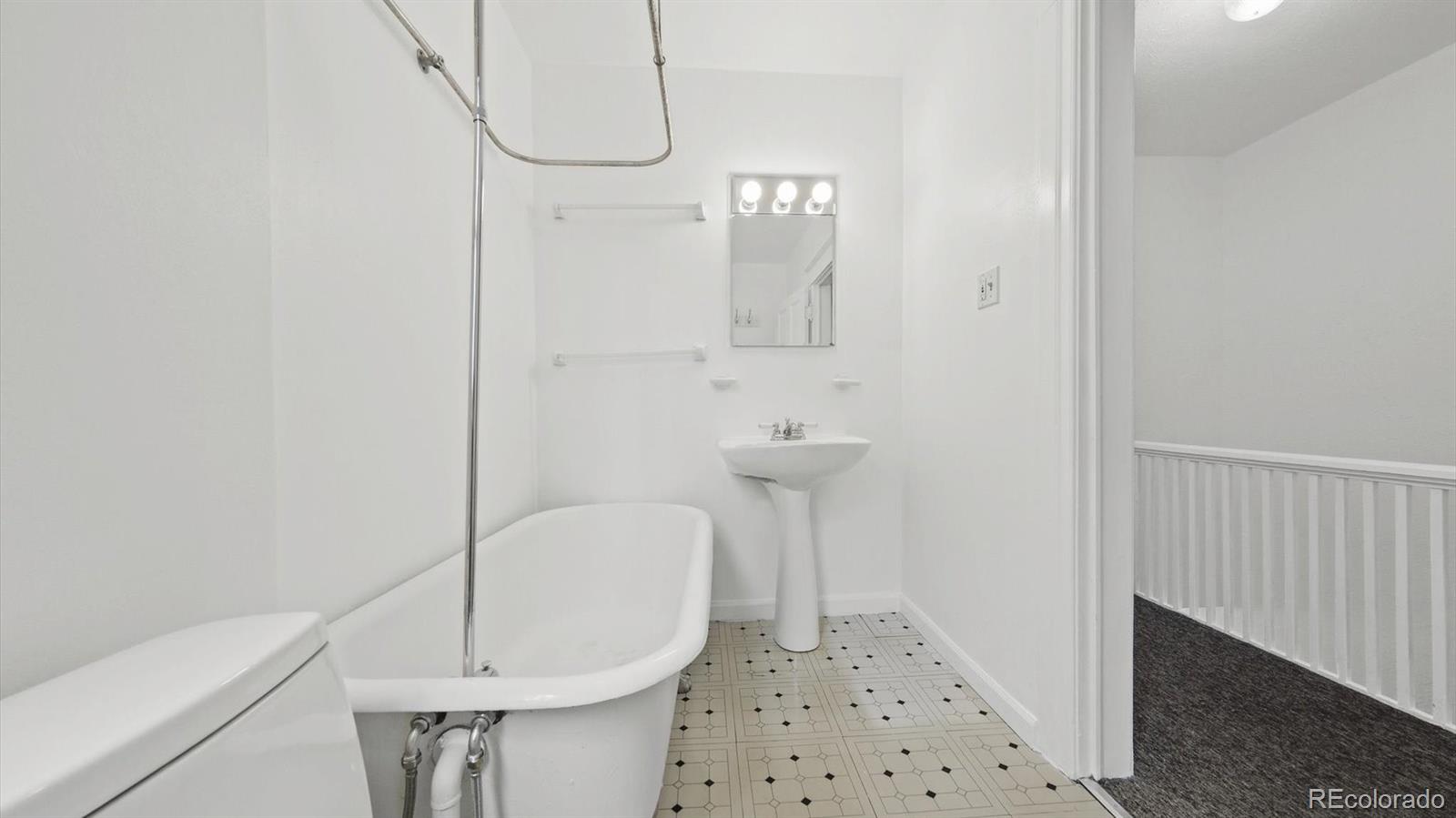 553 Logan Street Denver, CO 80203 - Photo 31 of 38 a bathroom with a sink a toilet and shower