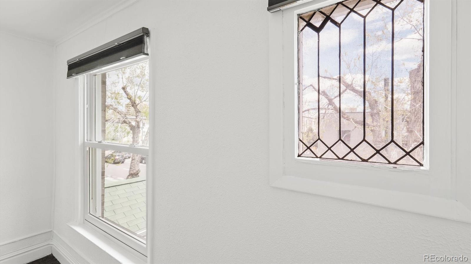 553 Logan Street Denver, CO 80203 - Photo 9 of 38 a white wall painting and a window