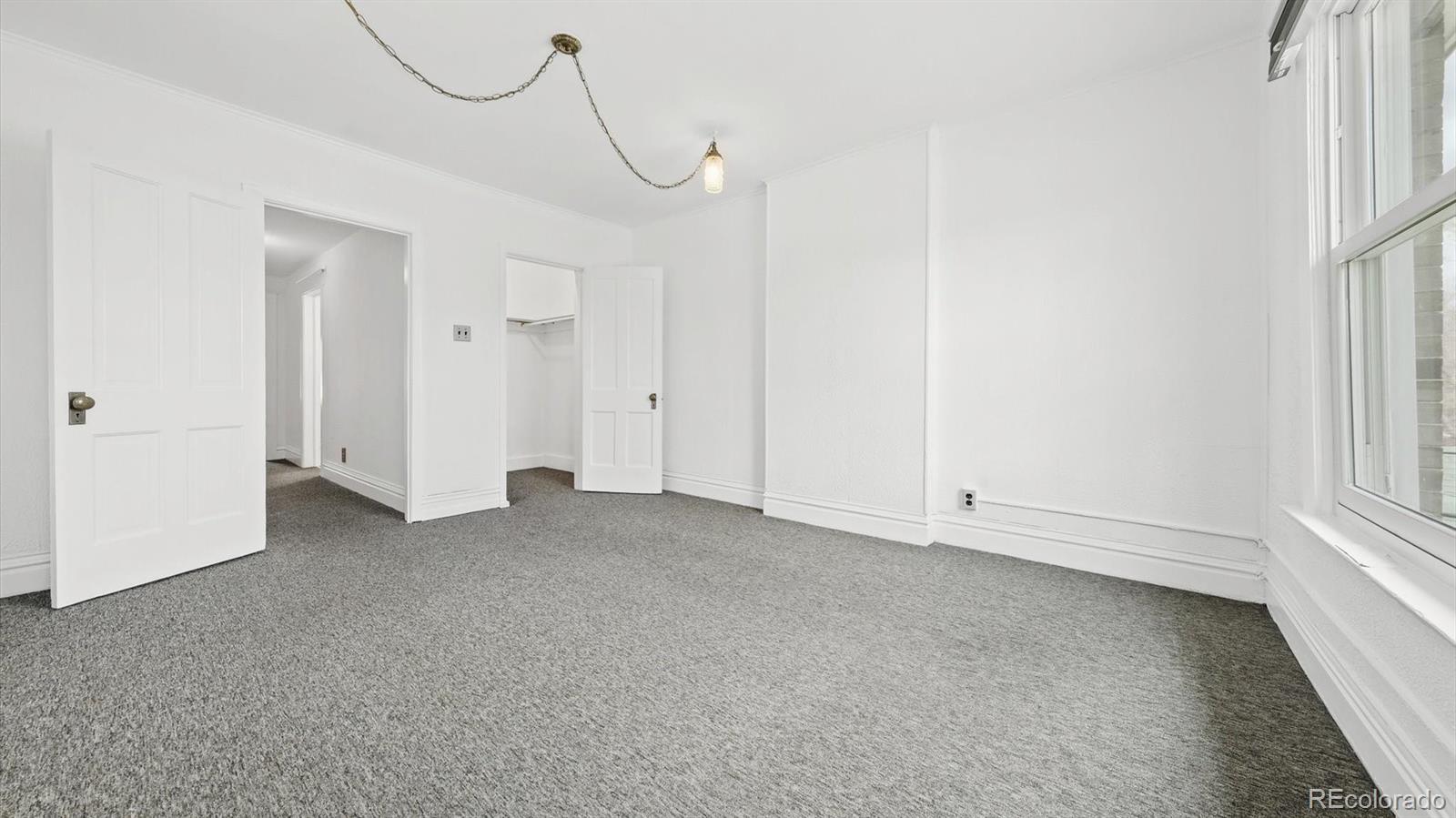 553 Logan Street Denver, CO 80203 - Photo 10 of 38 a view of an empty room with a window