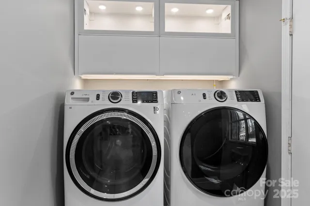 a view of a hallway with wooden floor and a bathroom