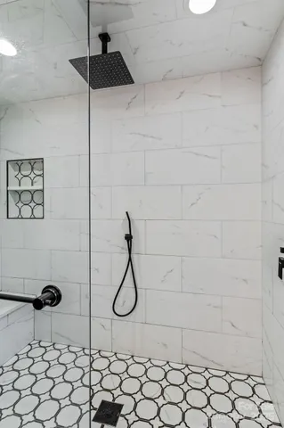 a living room with a fireplace furniture a walk in closet and a window