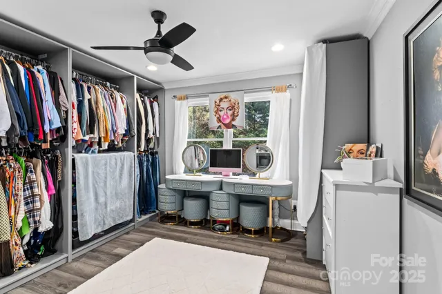 a bedroom with a bed and a mirror on dresser