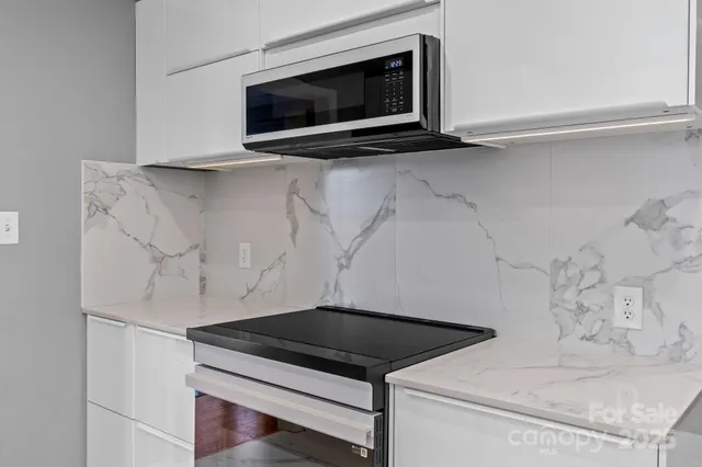 a bathroom with a sink a mirror and shower