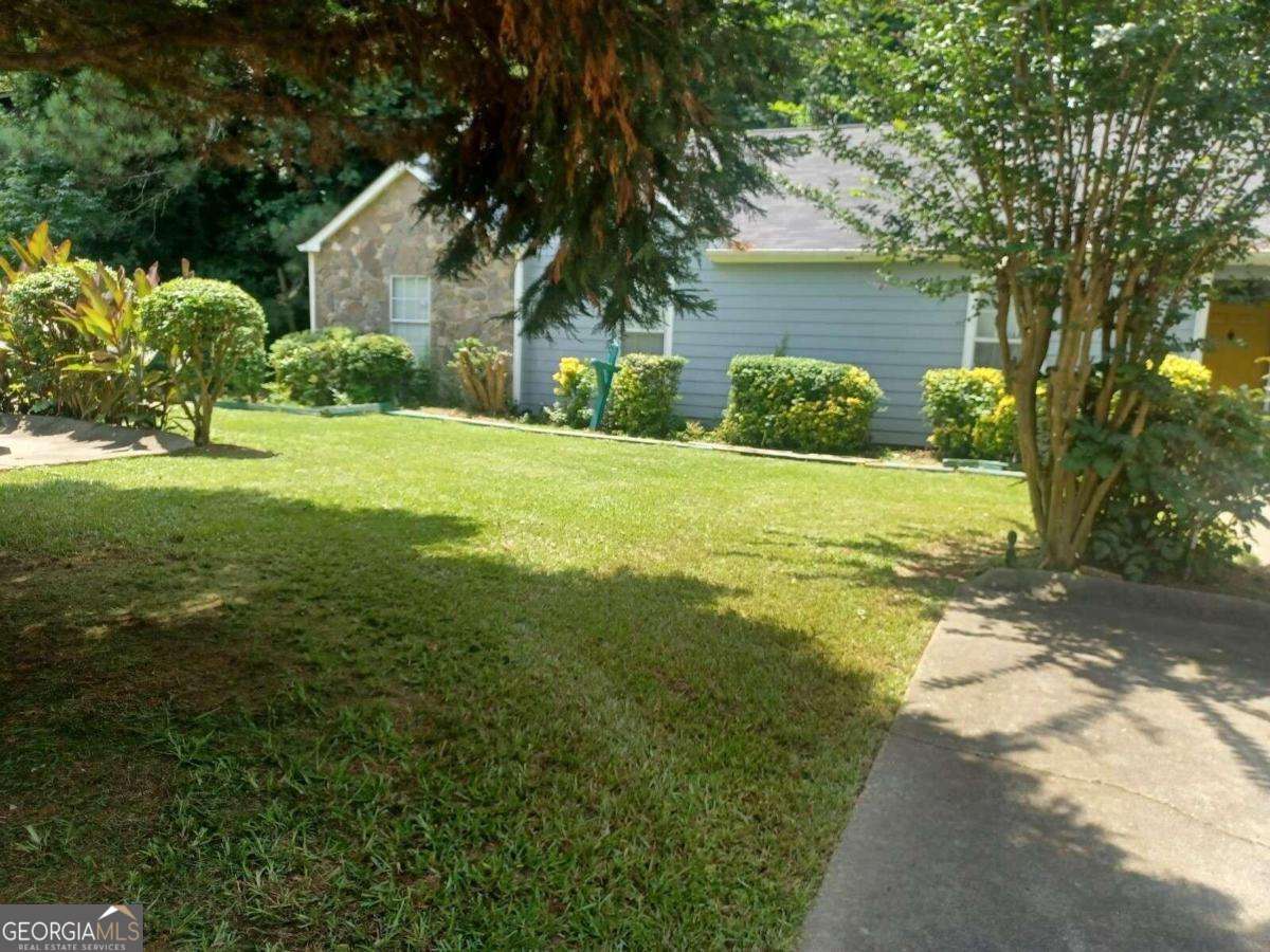5435 Glen Haven Drive Atlanta, GA 30349 - Photo 1 of 12 a front view of house with yard and green space