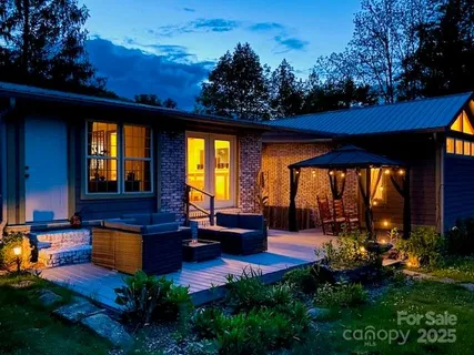 a view of a house with sitting area and garden