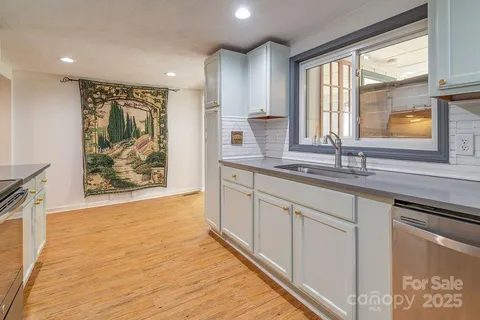a dining room with furniture wooden floor a rug and a chandelier