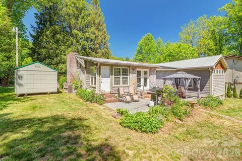a view of a backyard with sitting area