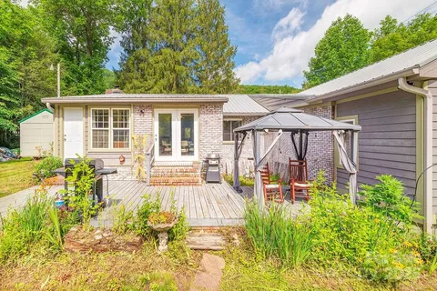 a view of a house with backyard sitting area and garden