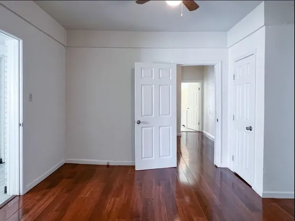 a view of a room with wooden floor