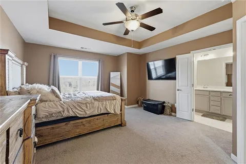 a spacious bedroom with a bed and a walk in closet