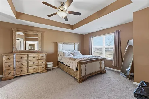 a bed room with a bed and a ceiling fan