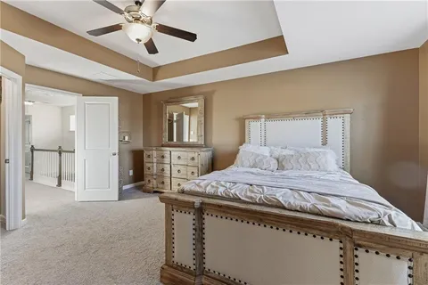 a en suite bathroom with a granite countertop sink and a mirror