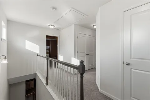 a view of a hallway with entryway door