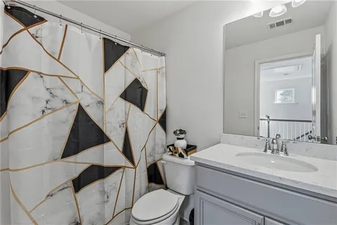 a bathroom with a toilet a sink and a mirror