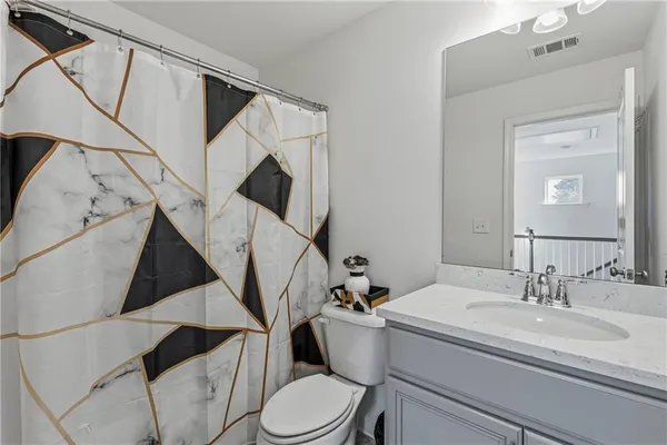 a bathroom with a toilet a sink and a mirror