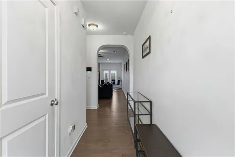 a view of a hallway with wooden floor and staircase