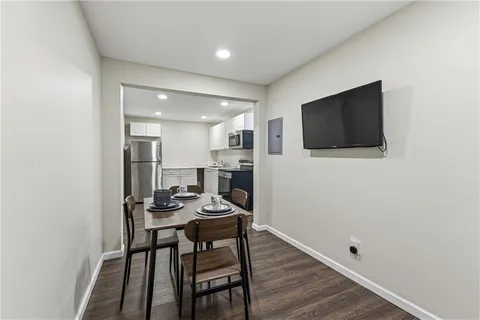 a view of a dining room with furniture and wooden floor