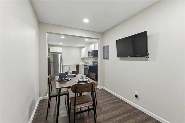a view of a dining room with furniture and wooden floor