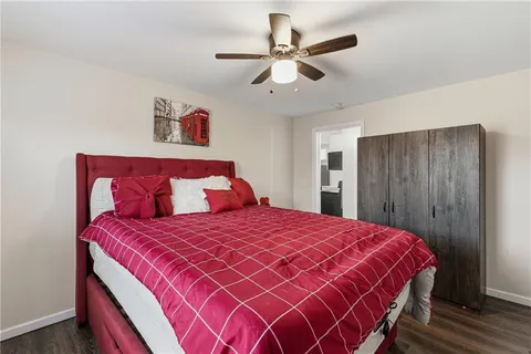 a bedroom with a large bed and a chandelier