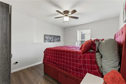 a bedroom with a bed and a fan