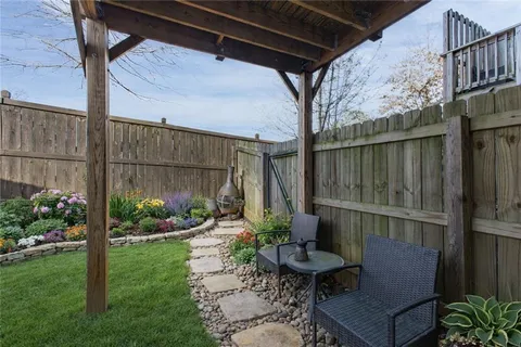 a view of a chair and table in backyard