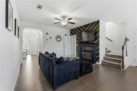 a living room with furniture and wooden floor
