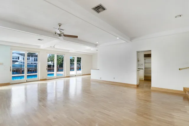 a kitchen with granite countertop a sink and white cabinets