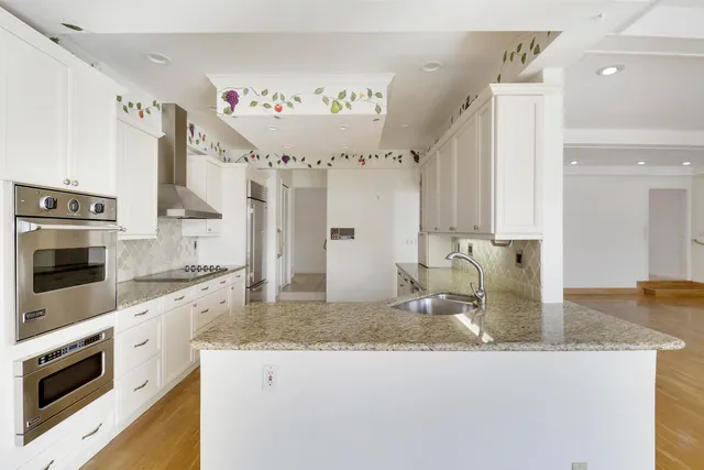a view of roof deck with a barbeque and wooden stairs