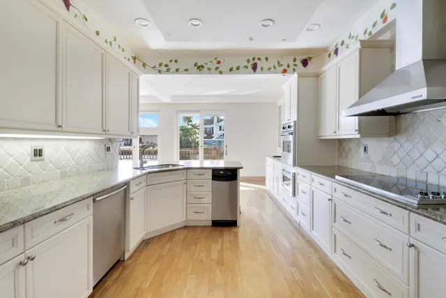 a dining room with furniture and a potted plant