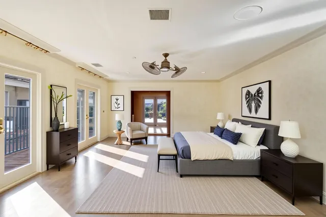a bedroom with a large bed and a potted plant