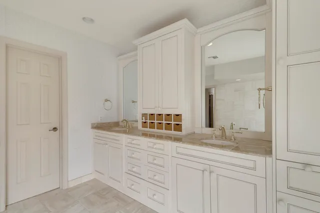 a bedroom with a bed and a potted plant