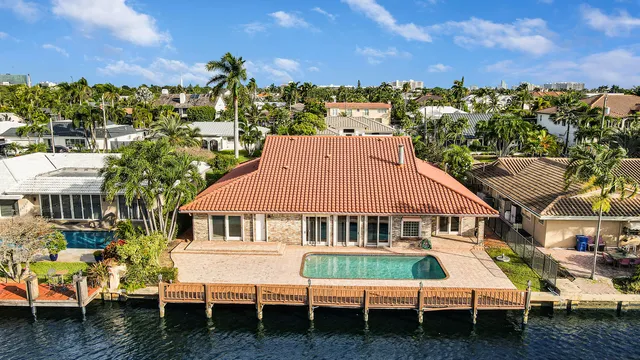a view of a city with lots of residential buildings ocean and mountain view in back