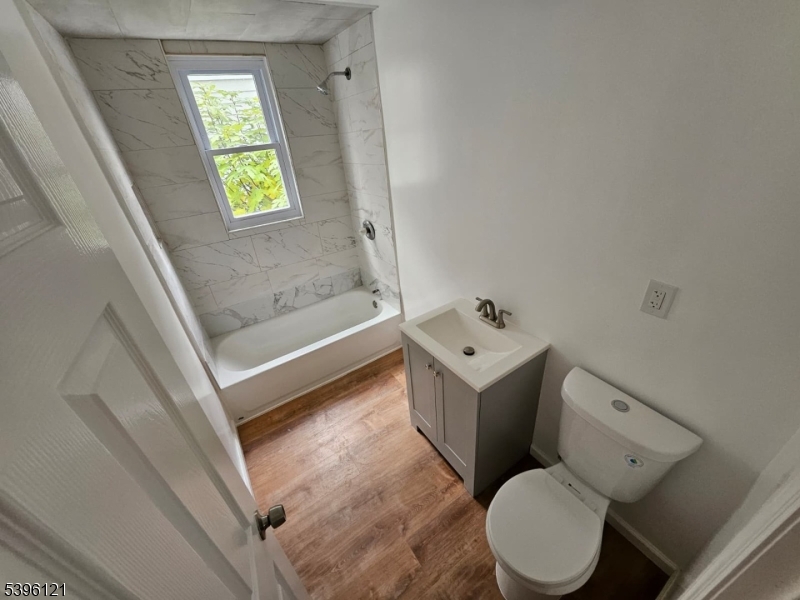 518 East 23rd Street, Unit 2R Paterson, NJ 07514 - Photo 2 of 7 a white toilet sitting next to a bath tub