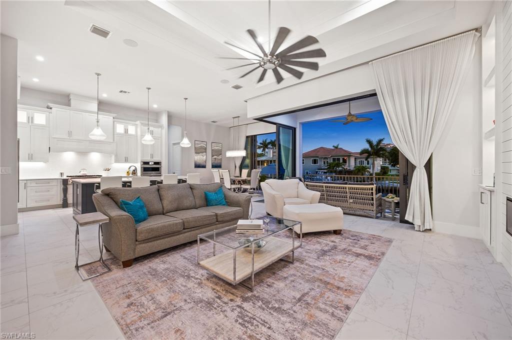 388 Pine Avenue Naples, FL 34108 - Photo 32 of 34 a living room with furniture and a chandelier