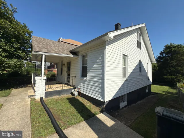 a view of house with backyard and sitting area