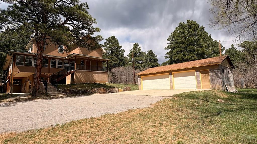 8295 Green Lane Rye, CO 81069 - Photo 2 of 88 a front view of a house with a yard and garage