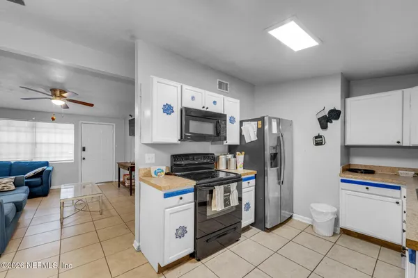 a kitchen with stainless steel appliances a refrigerator stove and microwave