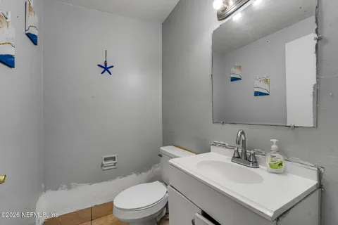 a bathroom with a sink a toilet and mirror